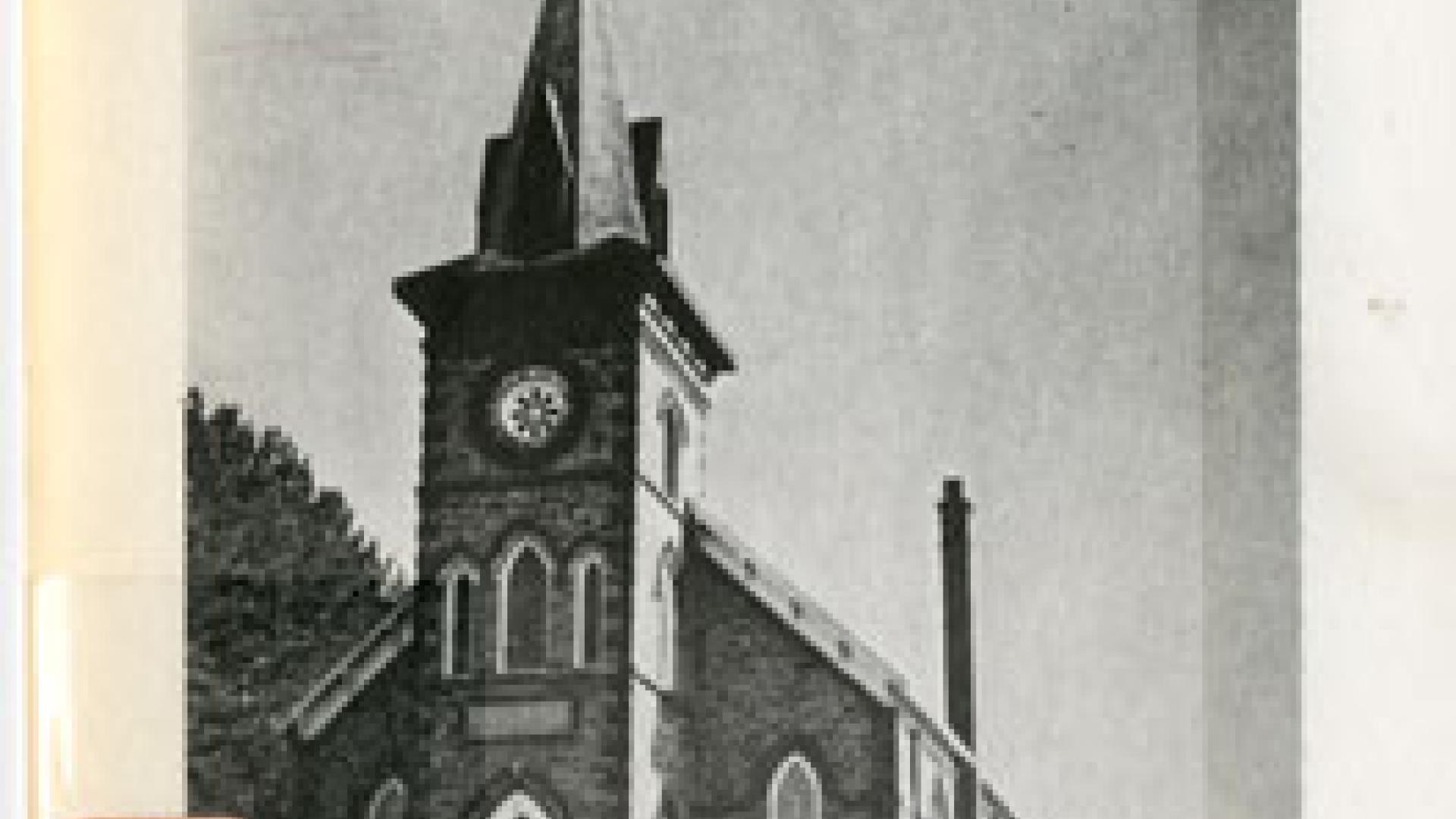 Cover of a book detailing the centennial of the St Patrick's Parish. The cover contains a monochrome exterior image of the church.