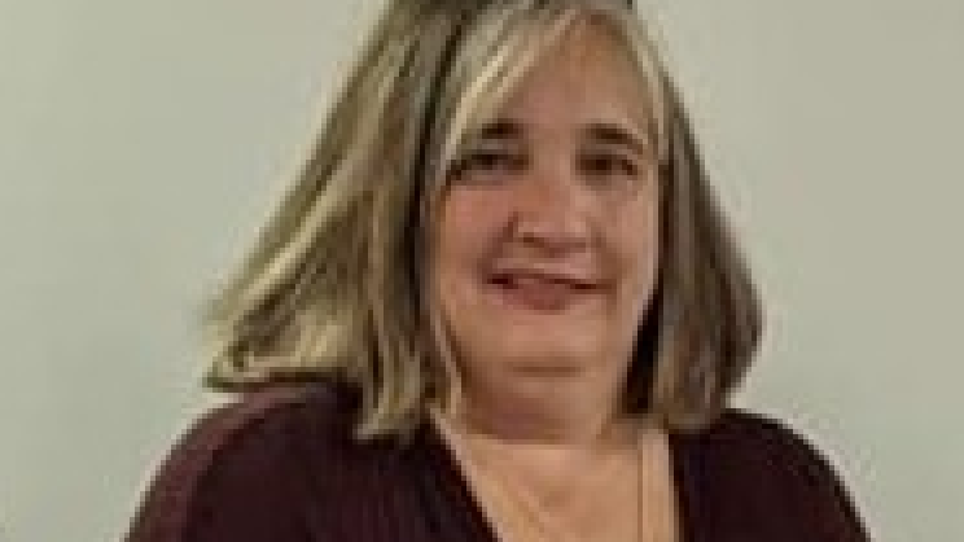 Headshot of Councillor Jill Sharer. There is a woman with straight auburn hair and a black shirt smiling.